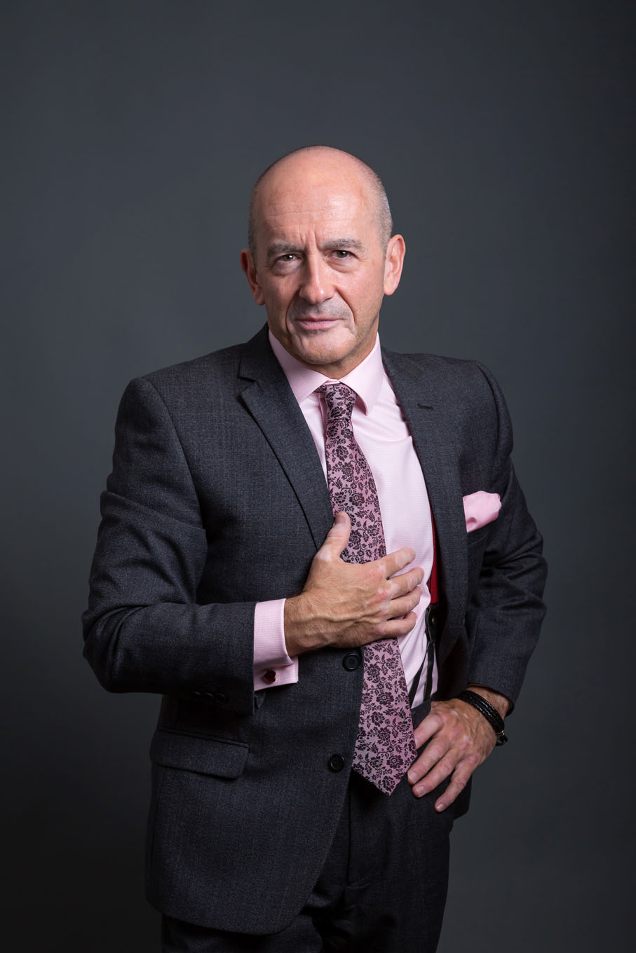 A portrait of a man taken in a studio set up with backdrop and lighting equipment